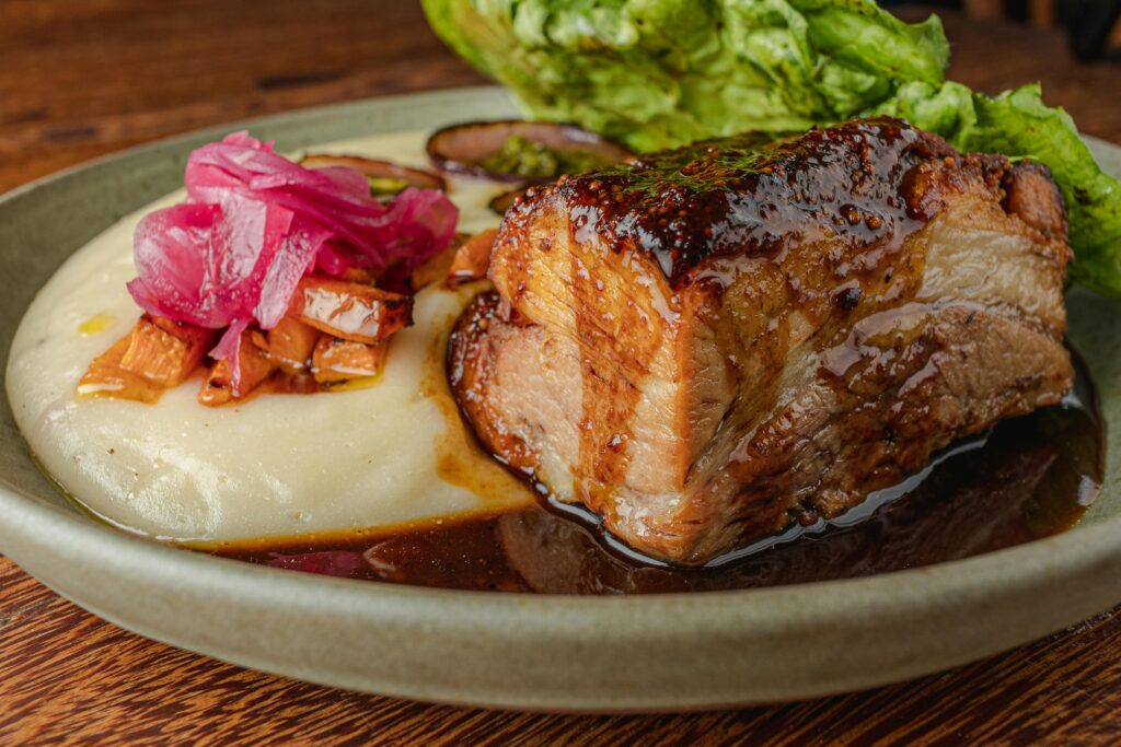 pexels photo 18303022 18303022 Delicious beef roast served with creamy puree, pickled onions, and fresh vegetables. Perfect food photography shot.