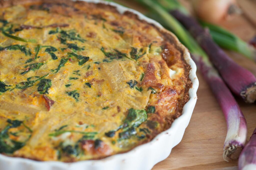 pexels photo 65173 65173 Delicious homemade quiche with fresh red onions and spinach, perfect for a tasty meal.